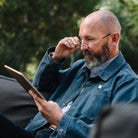 man with min readers reading ipad